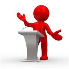 Speaking_at_podium.jpg